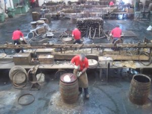 Die Arbeiter bei der Reparatur gebrauchter Fässer